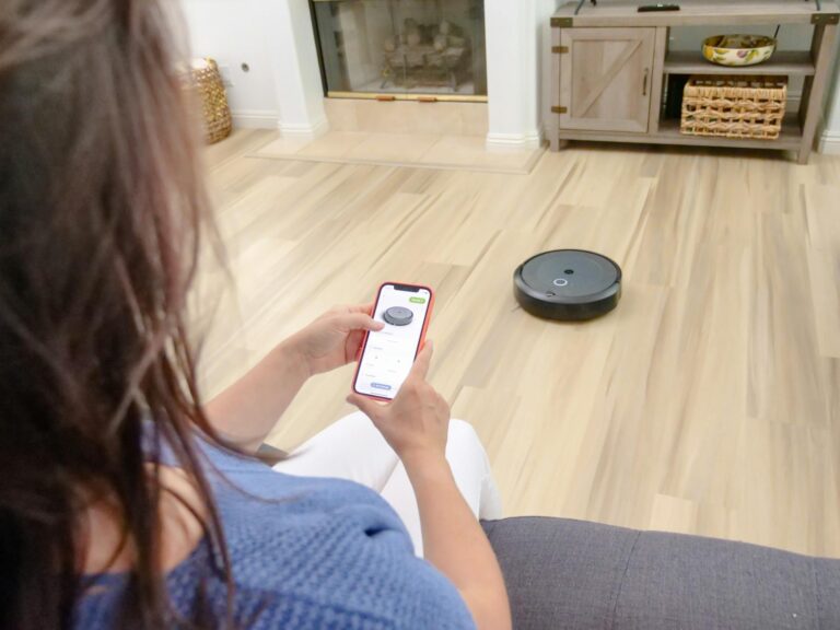 HIgh Angle Shot of Woman Operating the Vaccum Cleaner